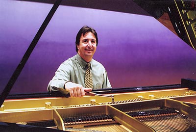 Photo of piano service professional TJ Terricola at the piano